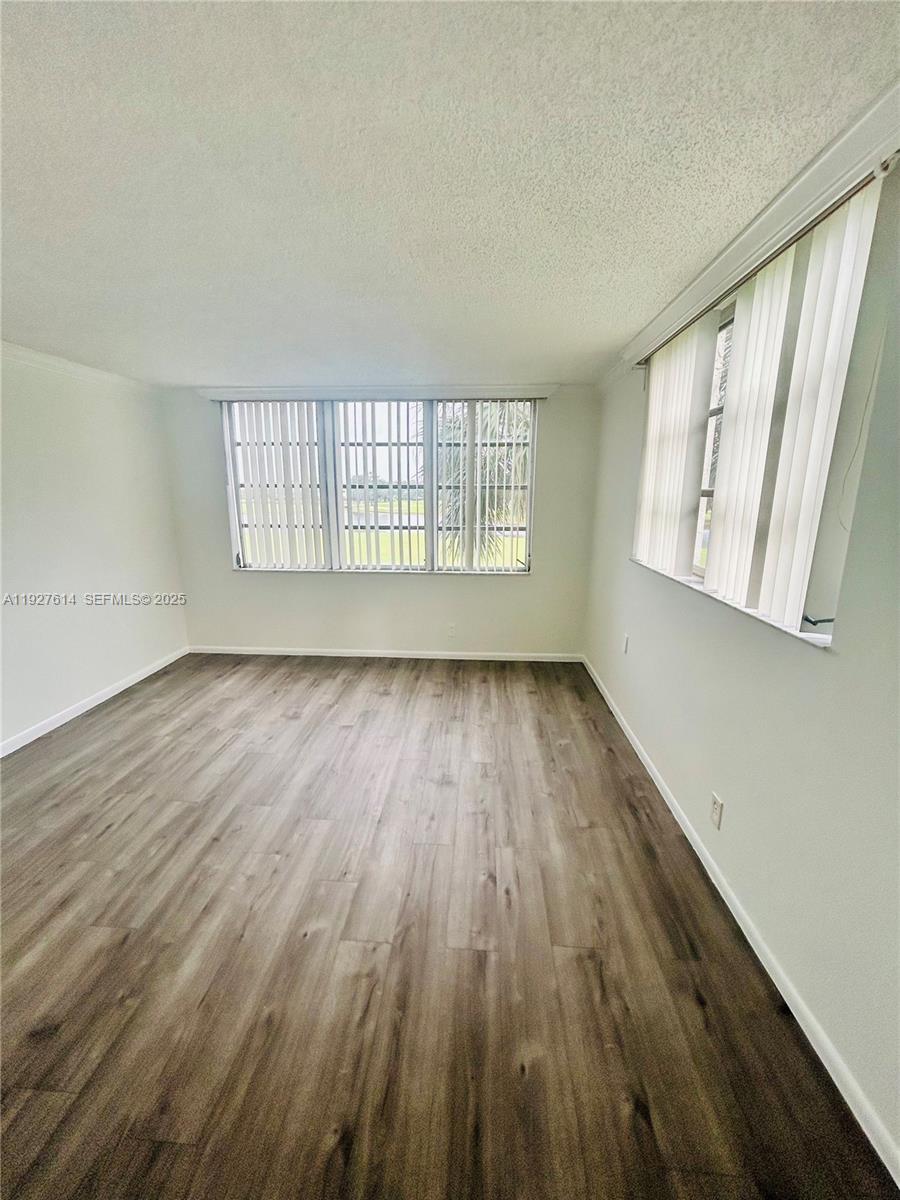 3100 West Rolling Hills Circle, Unit 310 Davie, FL 33328 - Photo 25 of 39 an empty room with wooden floor and windows