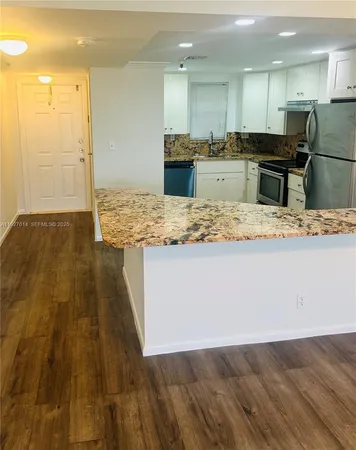 a view of kitchen with wooden floor