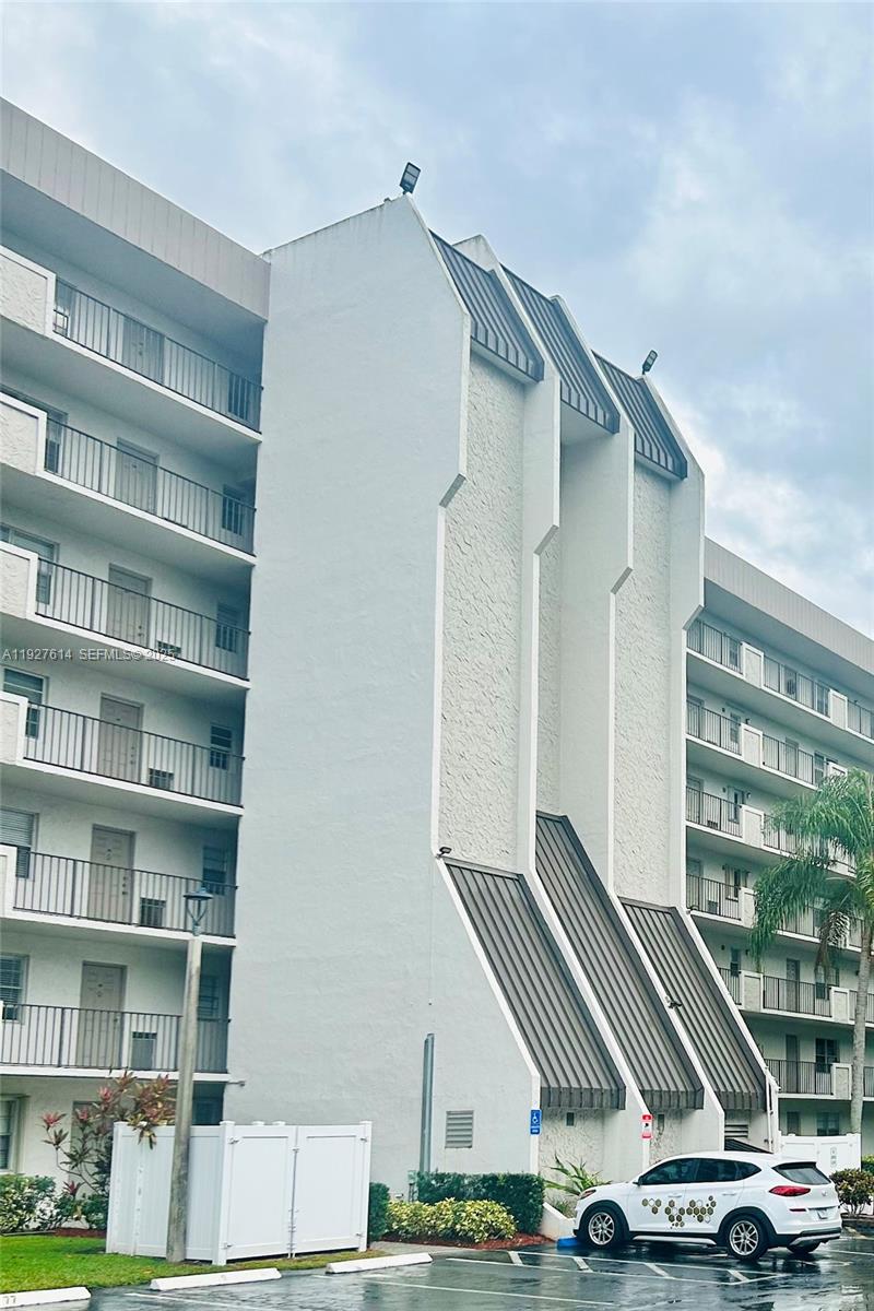 3100 West Rolling Hills Circle, Unit 310 Davie, FL 33328 - Photo 33 of 39 a view of car parked in front of building