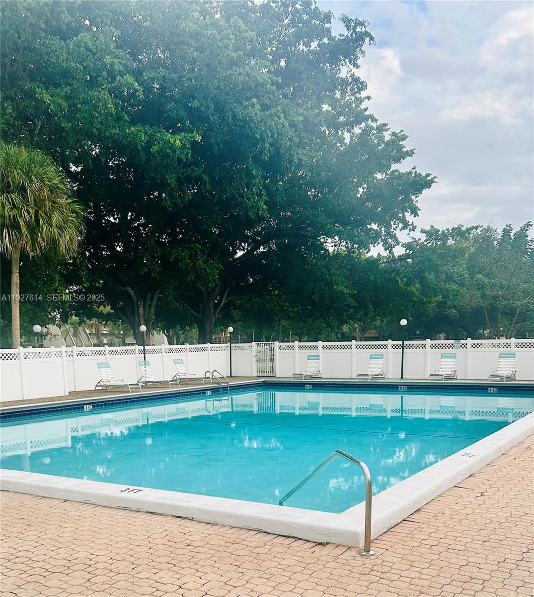 3100 West Rolling Hills Circle, Unit 310 Davie, FL 33328 - Photo 36 of 39 a view of a swimming pool with a yard