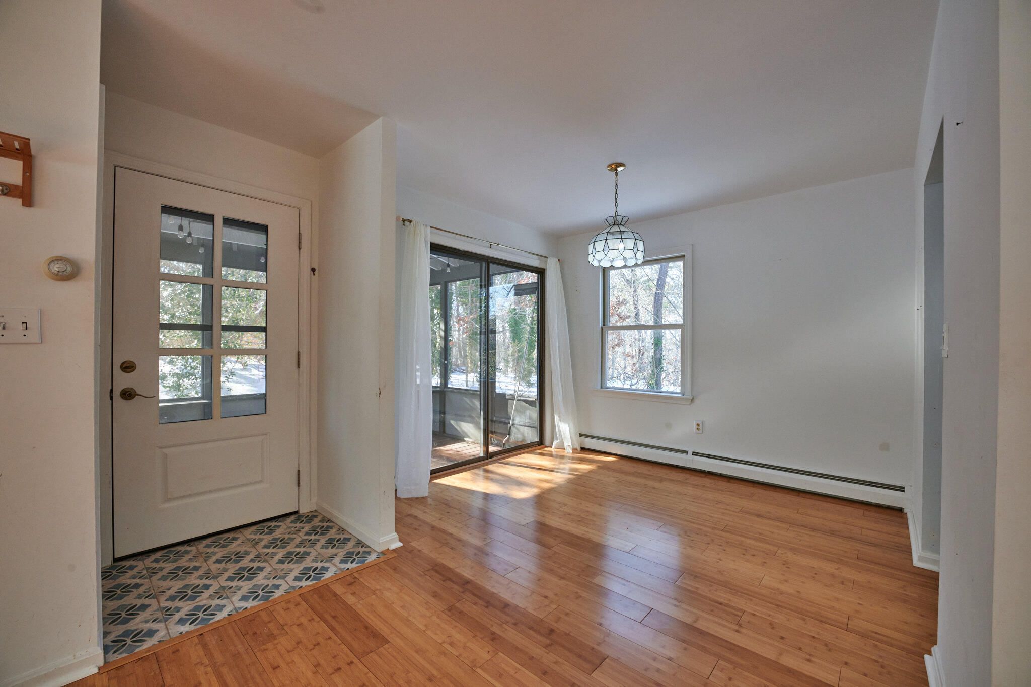14 Harold Street, Unit 14A Harwich Port, MA 02646 - Photo 5 of 23 an empty room with wooden floor cabinet and windows