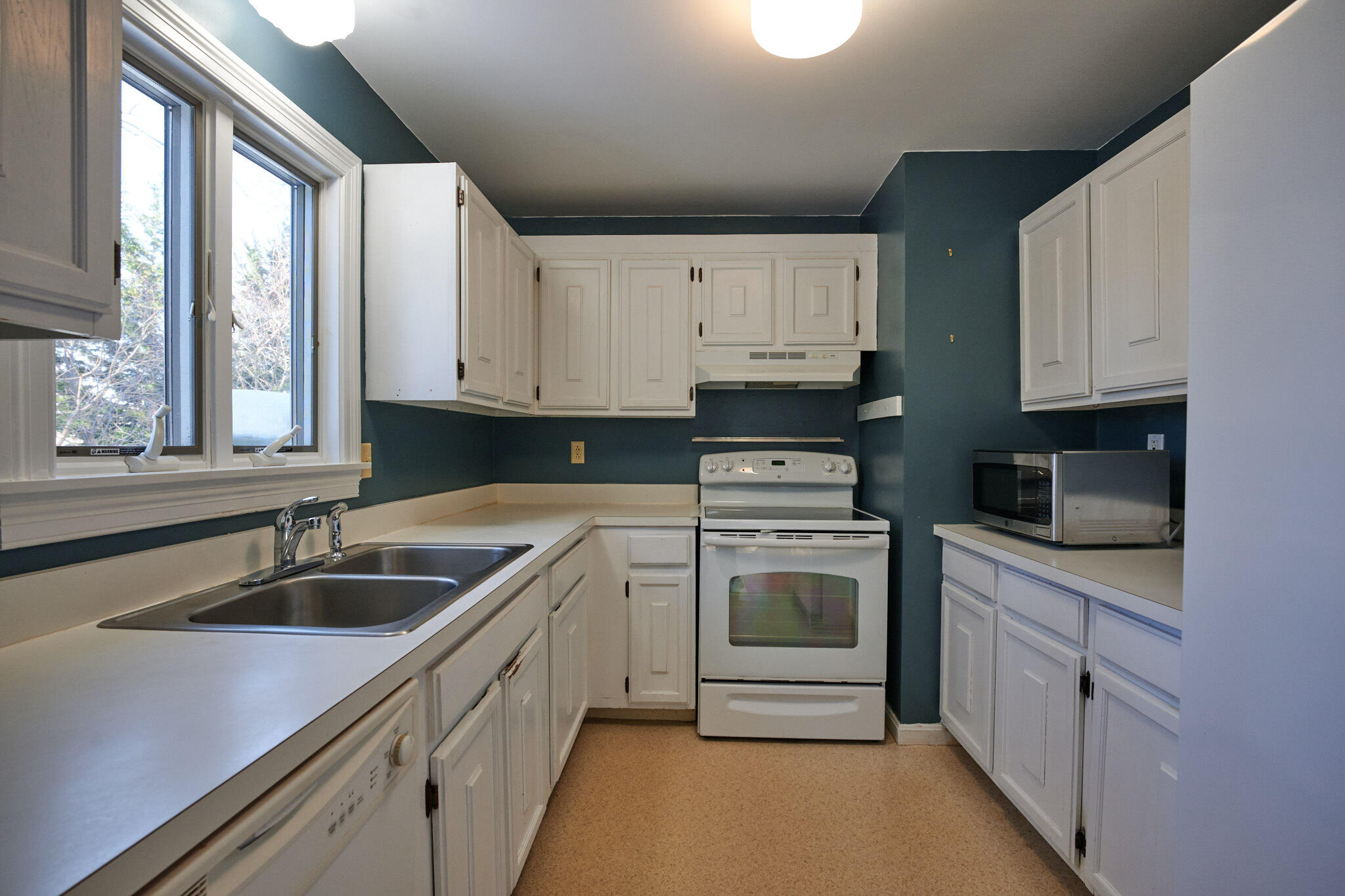 14 Harold Street, Unit 14A Harwich Port, MA 02646 - Photo 9 of 23 a kitchen with granite countertop white cabinets and white appliances