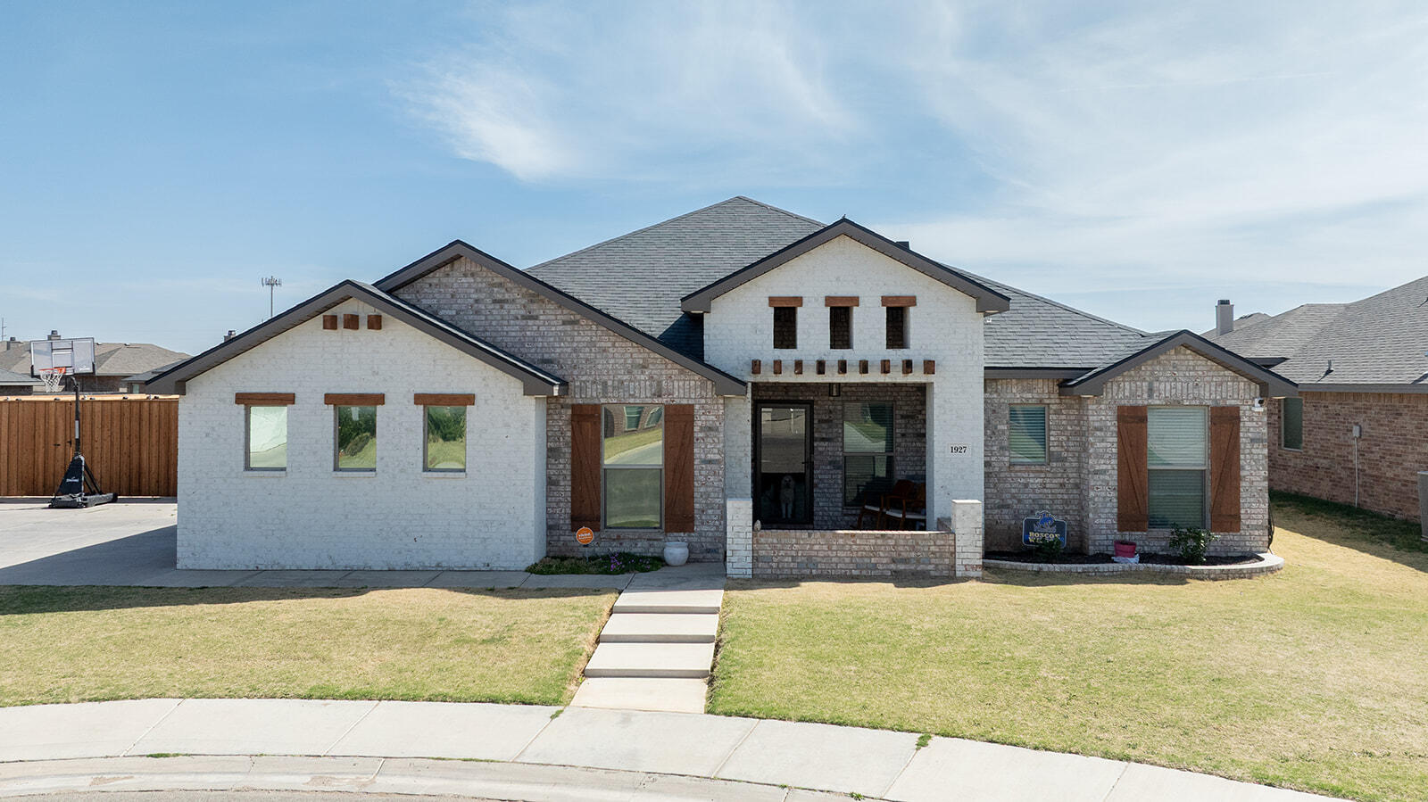 1927 142nd Street Lubbock, TX 79423 - Photo 3 of 58 a front view of a house with a yard