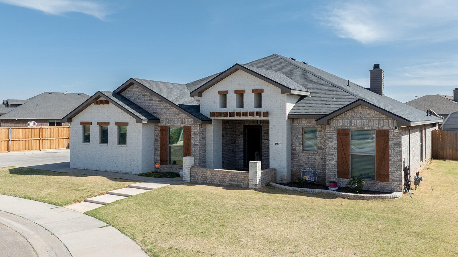 1927 142nd Street Lubbock, TX 79423 - Photo 4 of 58 a front view of a house with a yard and garage