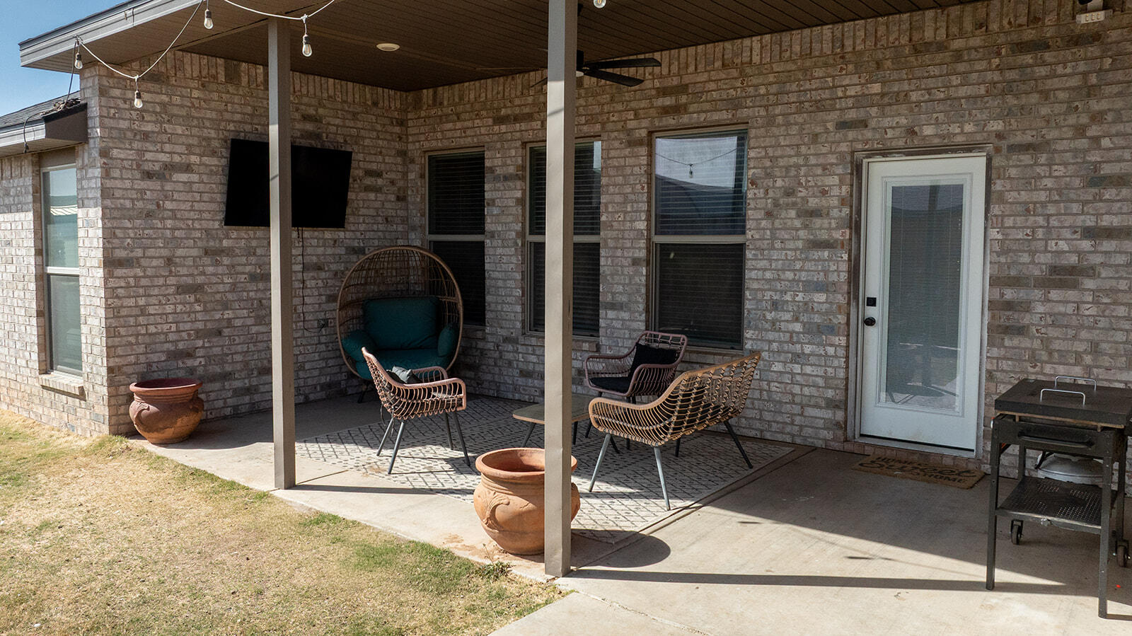 1927 142nd Street Lubbock, TX 79423 - Photo 53 of 58 a view of a patio with a table and chairs and potted plants