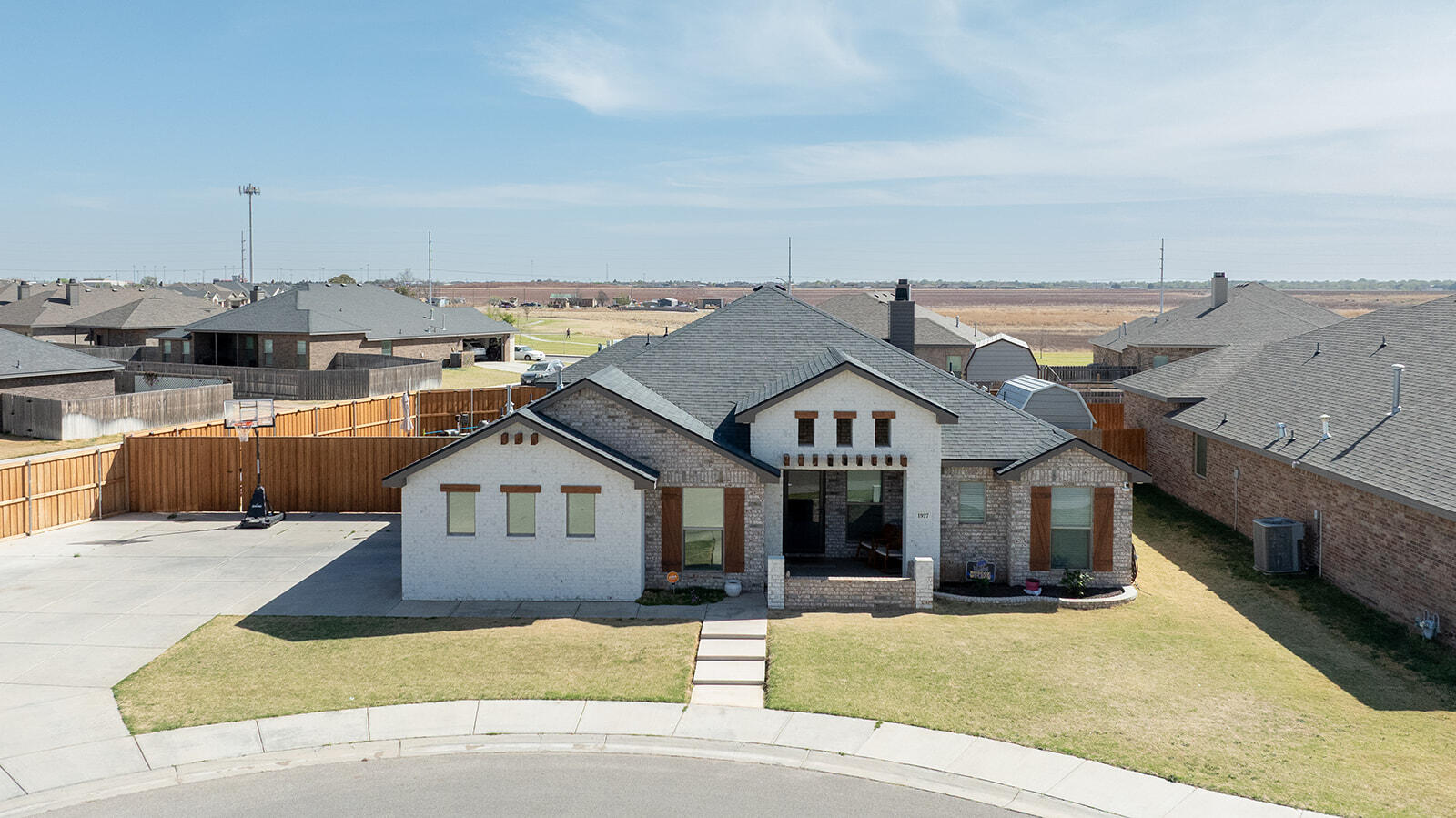 1927 142nd Street Lubbock, TX 79423 - Photo 57 of 58 a front view of a house with a yard