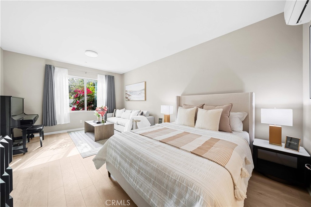115 Episode Irvine, CA 92618 - Photo 11 of 43 a spacious bedroom with a bed a couch and a flat tv screen on the dresser
