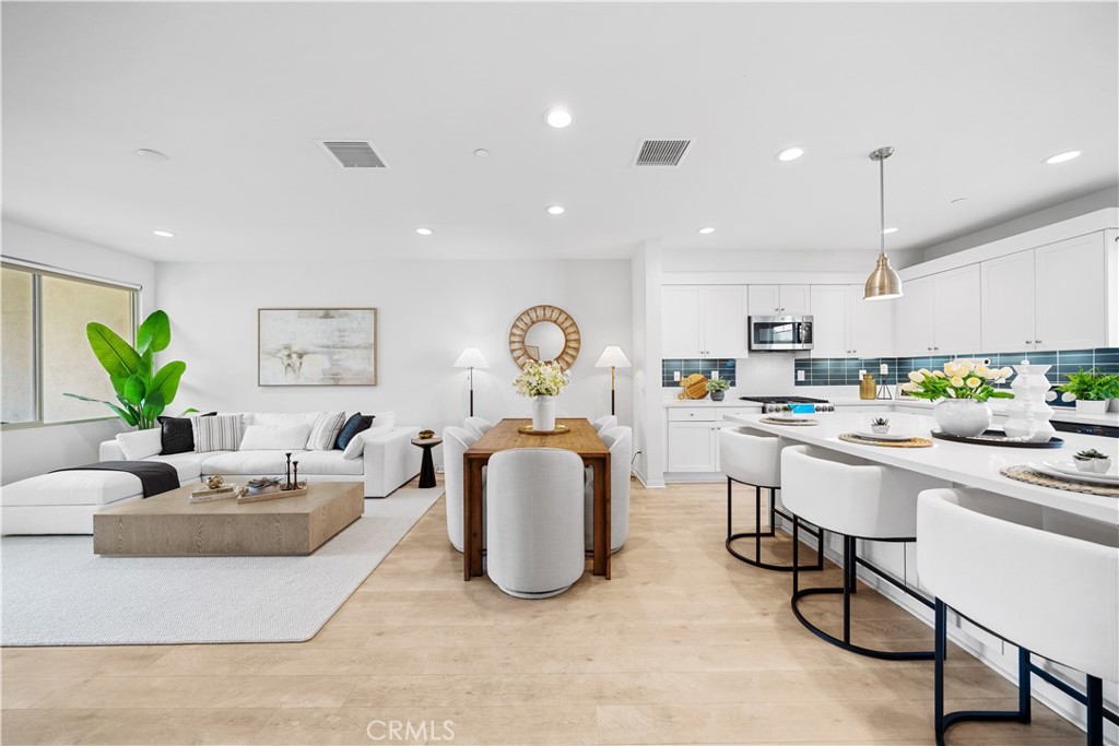 115 Episode Irvine, CA 92618 - Photo 13 of 43 a living room with kitchen island furniture and a potted plant