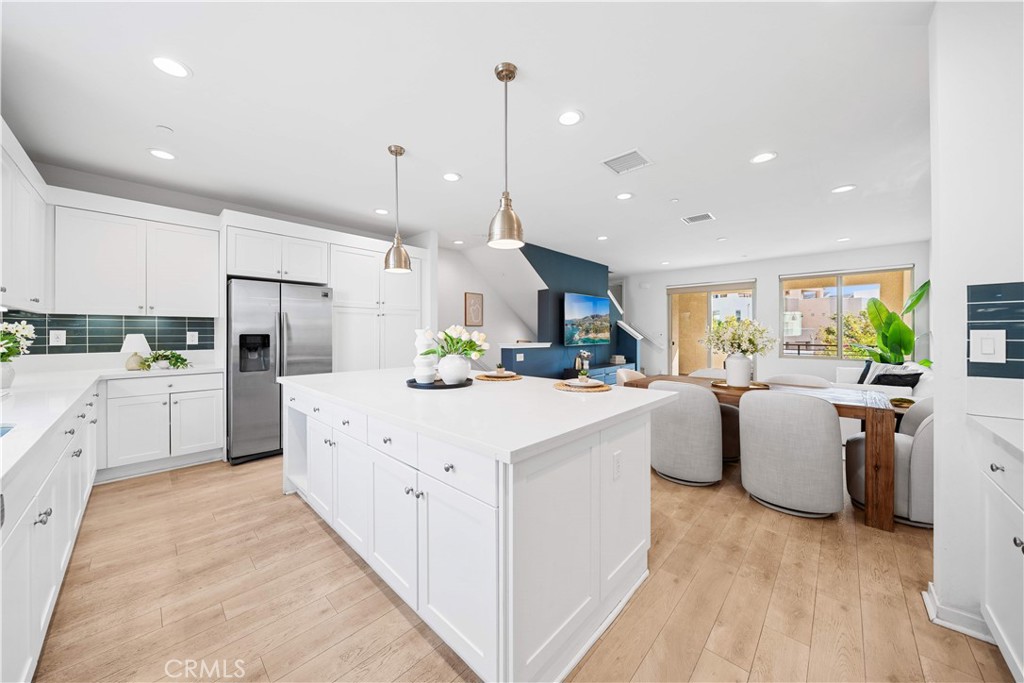 115 Episode Irvine, CA 92618 - Photo 17 of 43 a kitchen with white cabinets and stainless steel appliances