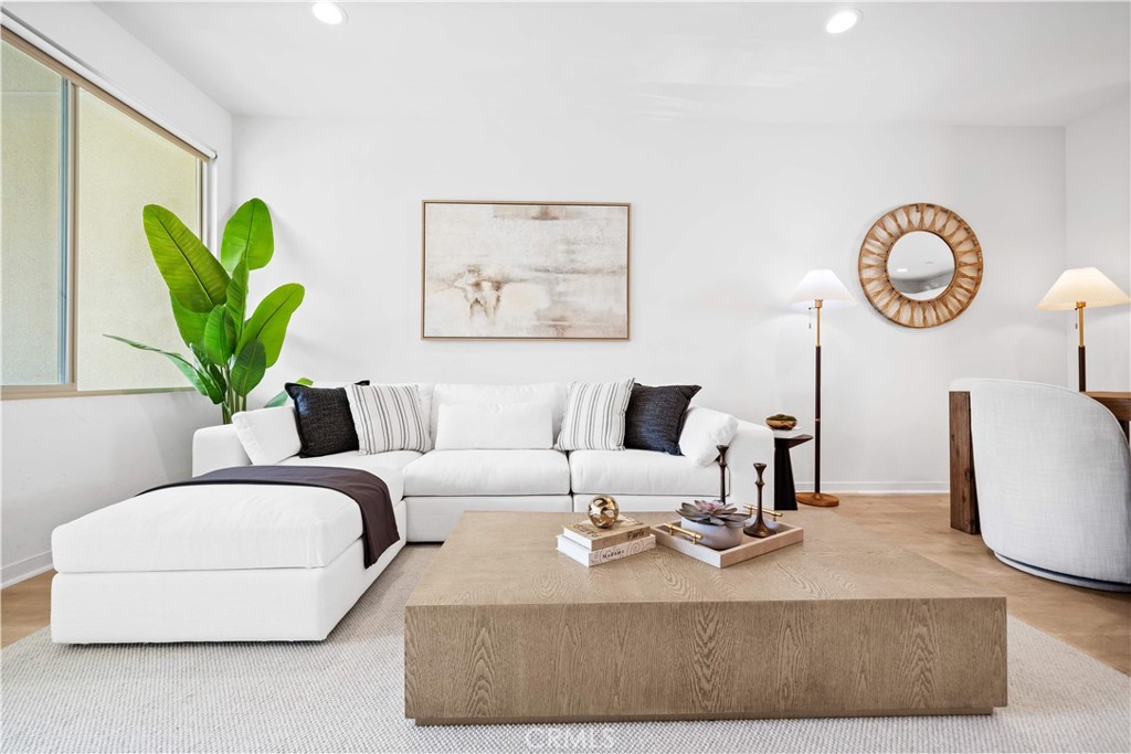 115 Episode Irvine, CA 92618 - Photo 21 of 43 a living room with furniture a clock and a potted plant