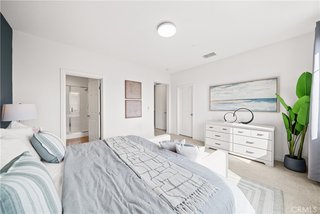 115 Episode Irvine, CA 92618 - Photo 29 of 43 a bedroom with a bed and a potted plant