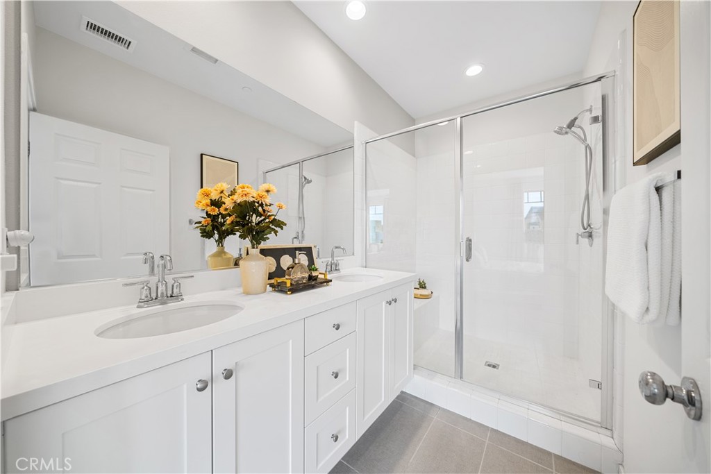 115 Episode Irvine, CA 92618 - Photo 30 of 43 a bathroom with a double vanity sink mirror and shower