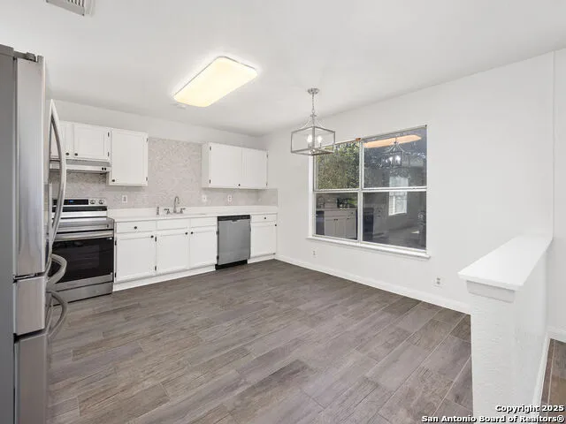 a view of a kitchen with microwave and cabinets