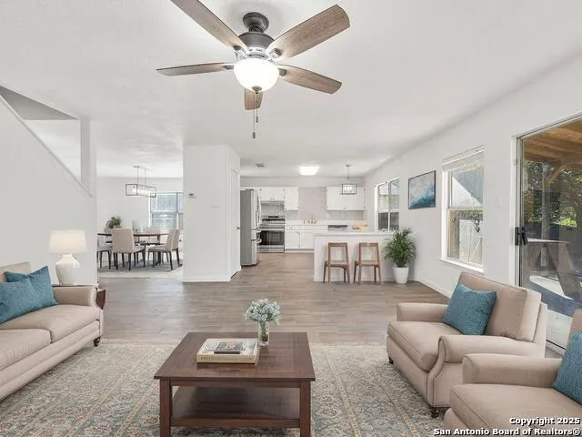 a living room with furniture and kitchen view