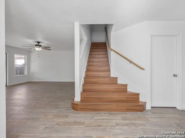 a view of entryway and hall with wooden floor