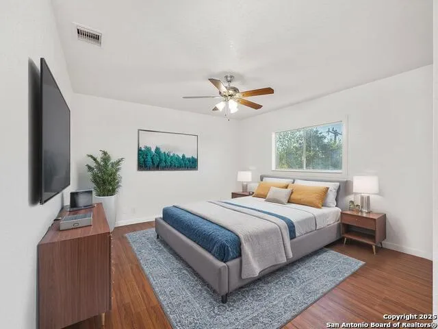 a bedroom with a large bed and a window