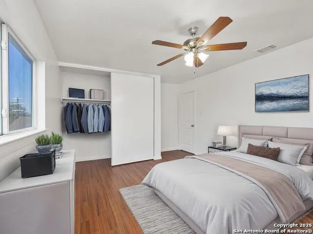 a bedroom with a bed and a couch