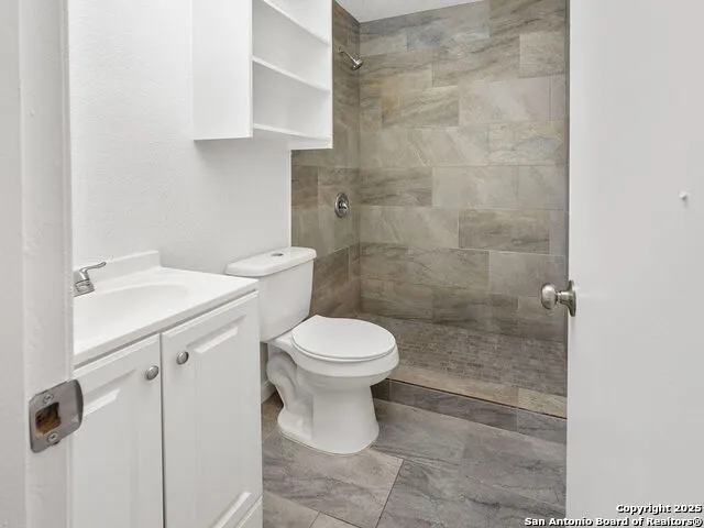 a bathroom with a toilet sink and shower