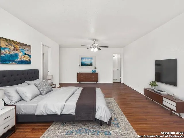 a bedroom with a large bed and a flat screen tv