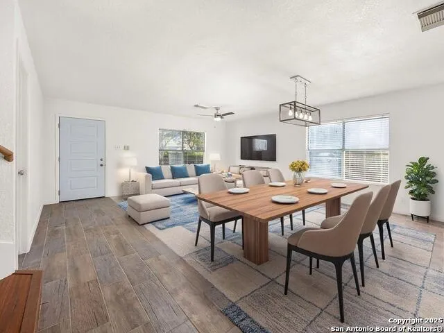 a view of a dining room with furniture and wooden floor
