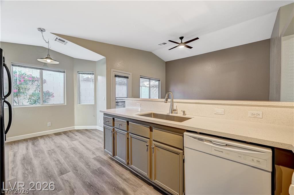 2283 Ramsgate Drive Henderson, NV 89074 - Photo 14 of 51 Vaulted ceilings and wood-look flooring enhance this kitchen overlooking the dining area.