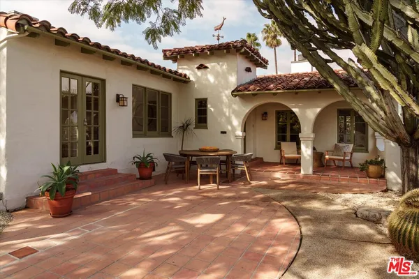 a view of a house with backyard porch and sitting area