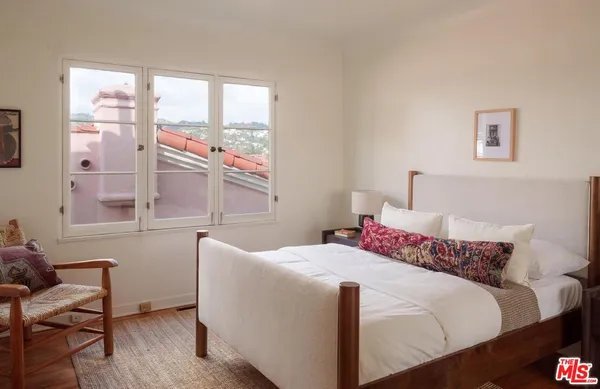 a bedroom with a bed and a chair