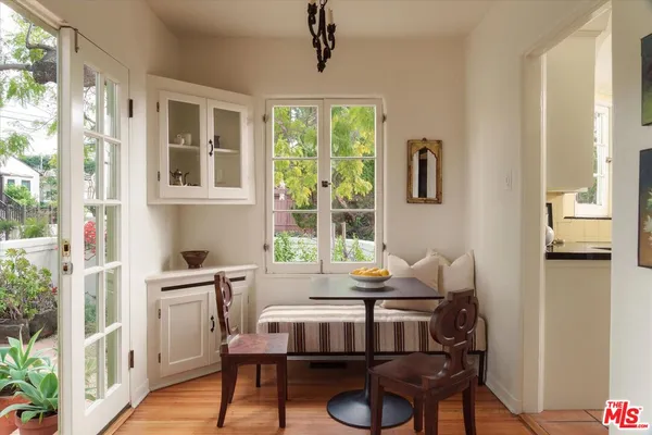a view of a dining room with furniture window and wooden floor