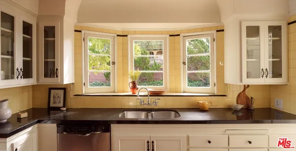 a kitchen with granite countertop a sink and a window