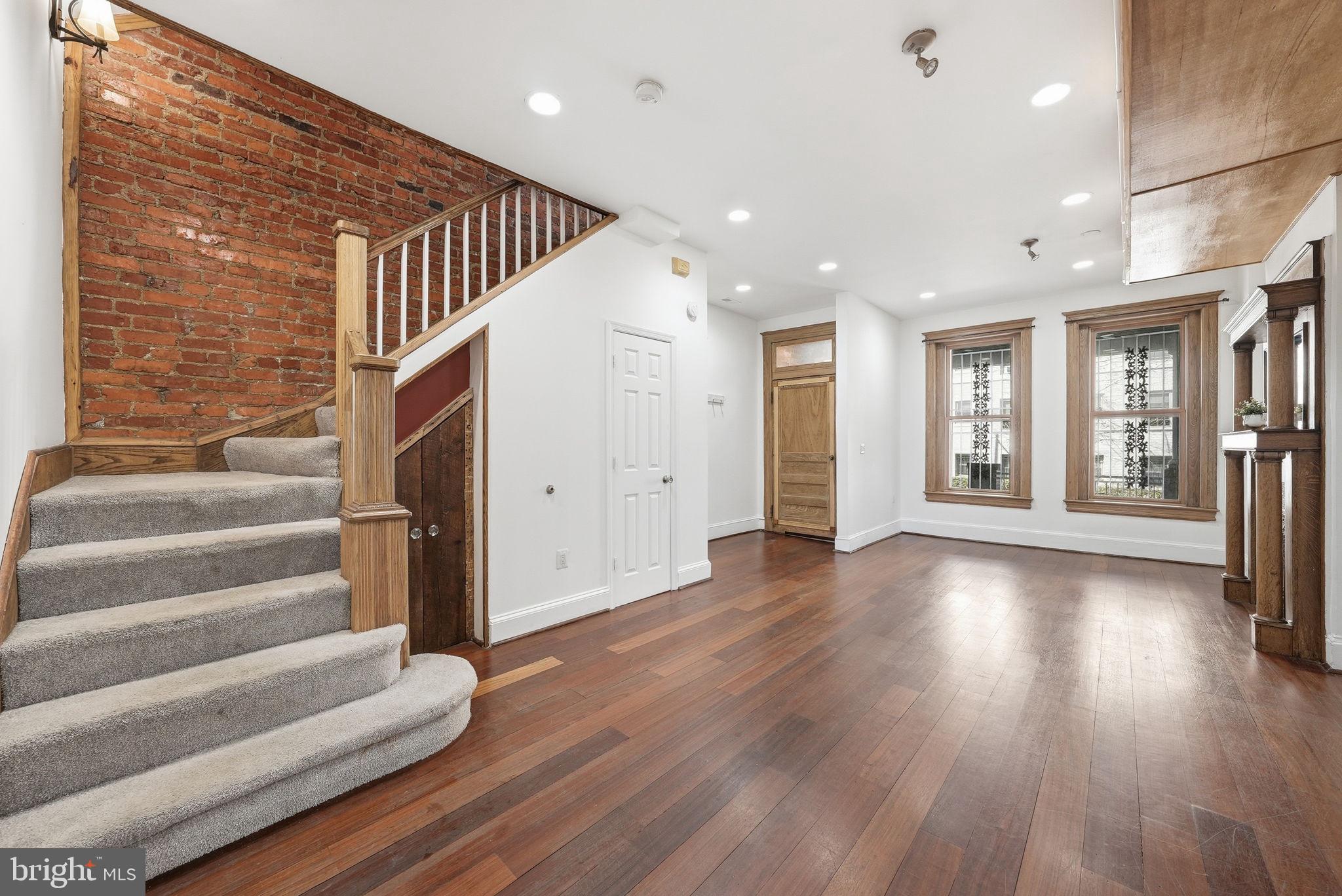 a view of an entryway with wooden floor and door