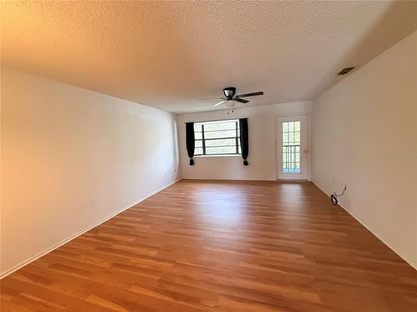 a view of wooden floor and windows in a room