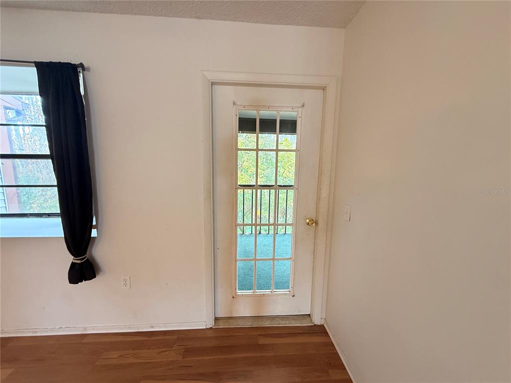 12155 Environmental Drive, Unit 6 New Port Richey, FL 34654 - Photo 17 of 42 an empty room with wooden floor and windows