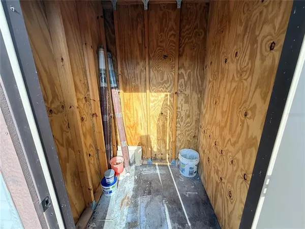 a view of a yard with plants and trees