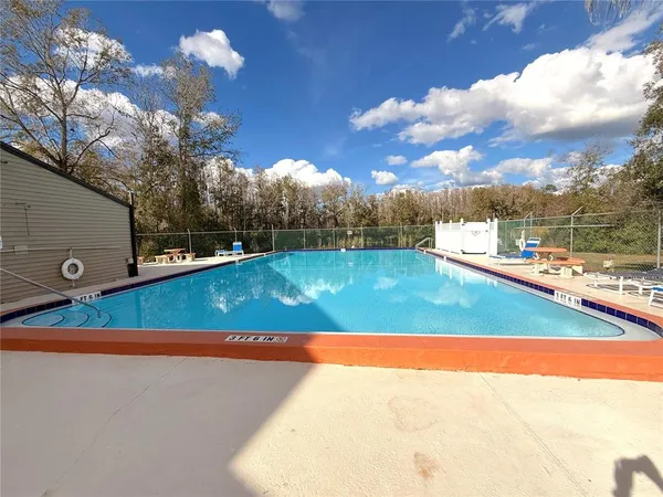 a living room with furniture a chandelier and a flat screen tv