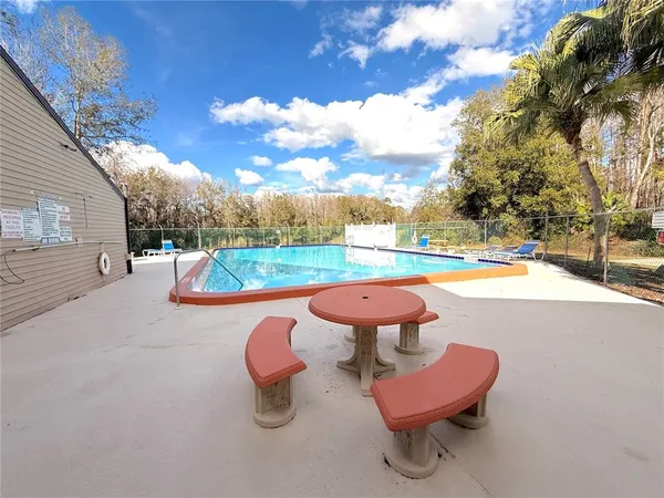 a living room with furniture and a pool table