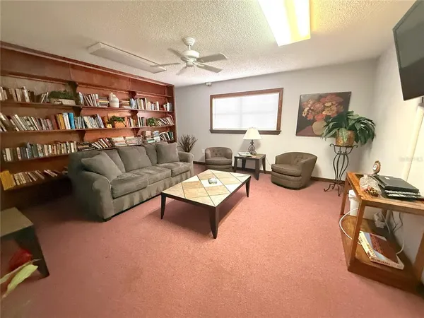 a view of a hall with kitchen and furniture