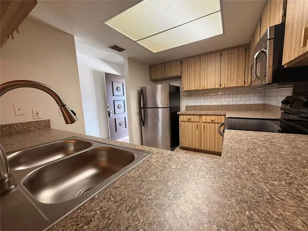 a kitchen with a sink and a refrigerator