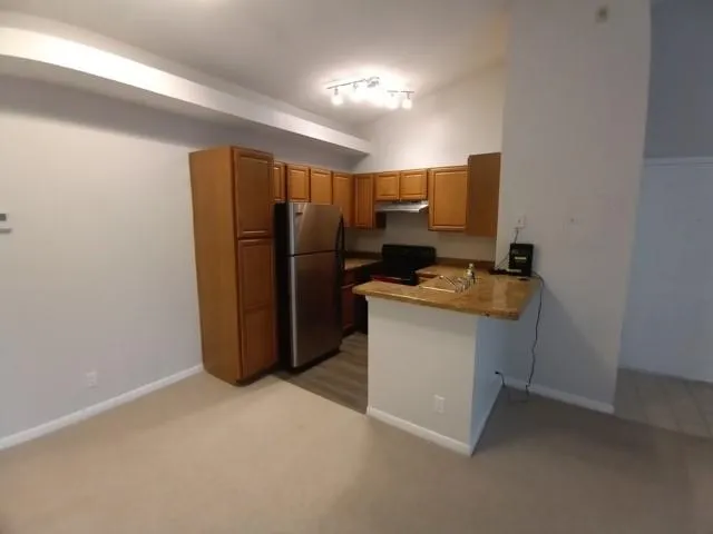 a kitchen with a refrigerator and a stove