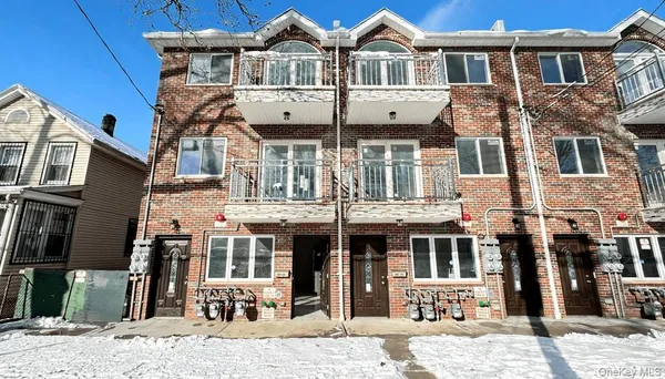 a front view of a residential apartment building with a yard