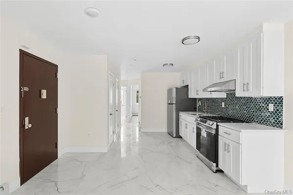a kitchen with stainless steel appliances granite countertop a refrigerator and a stove
