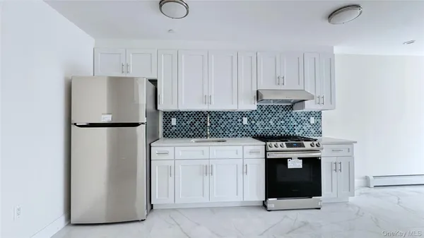 a kitchen that has a stove and a microwave