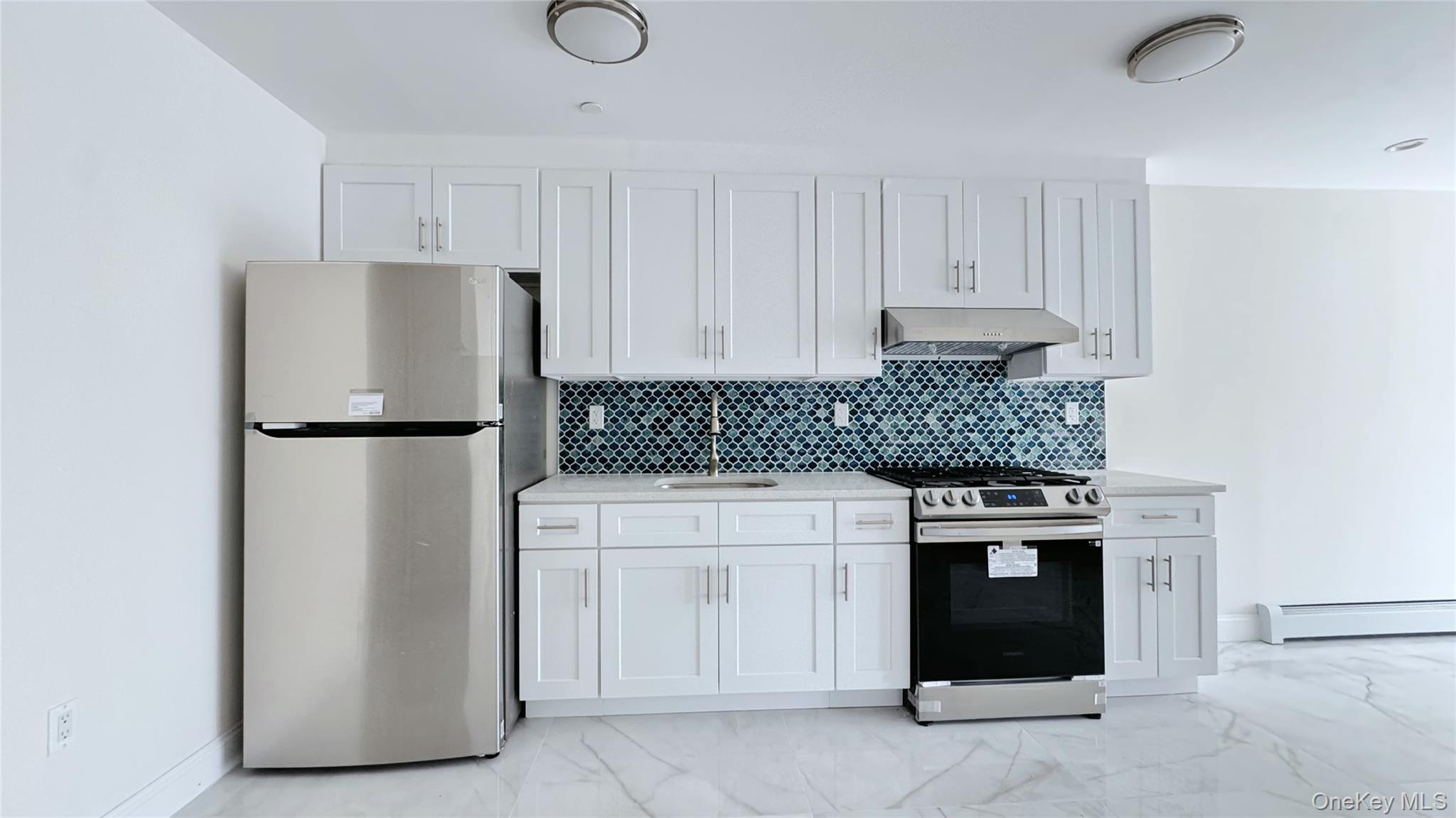 107-47 49th Avenue Queens, NY 11368 - Photo 13 of 41 a kitchen with stainless steel appliances granite countertop a refrigerator and a stove
