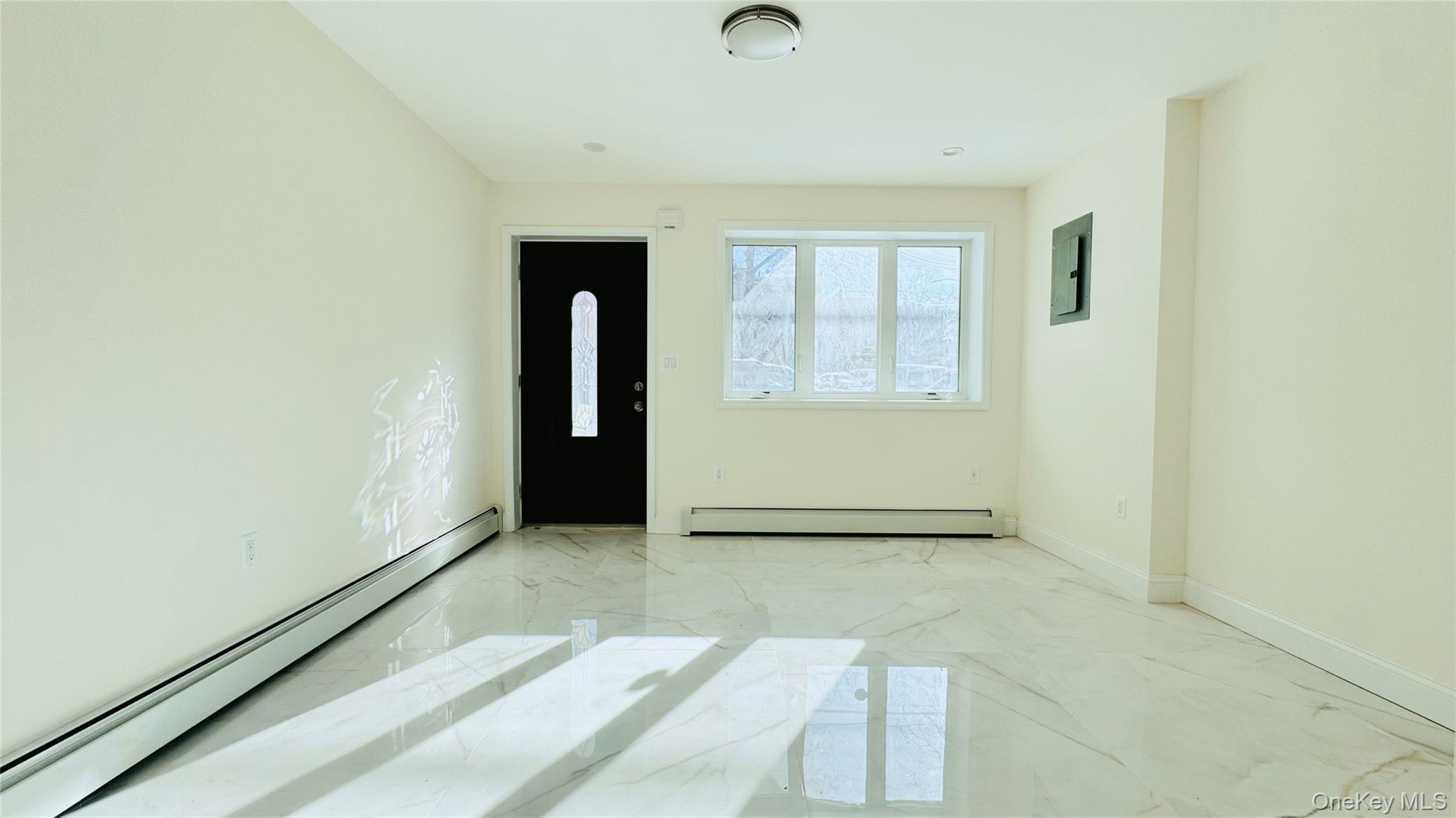 107-47 49th Avenue Queens, NY 11368 - Photo 3 of 41 an empty room with windows