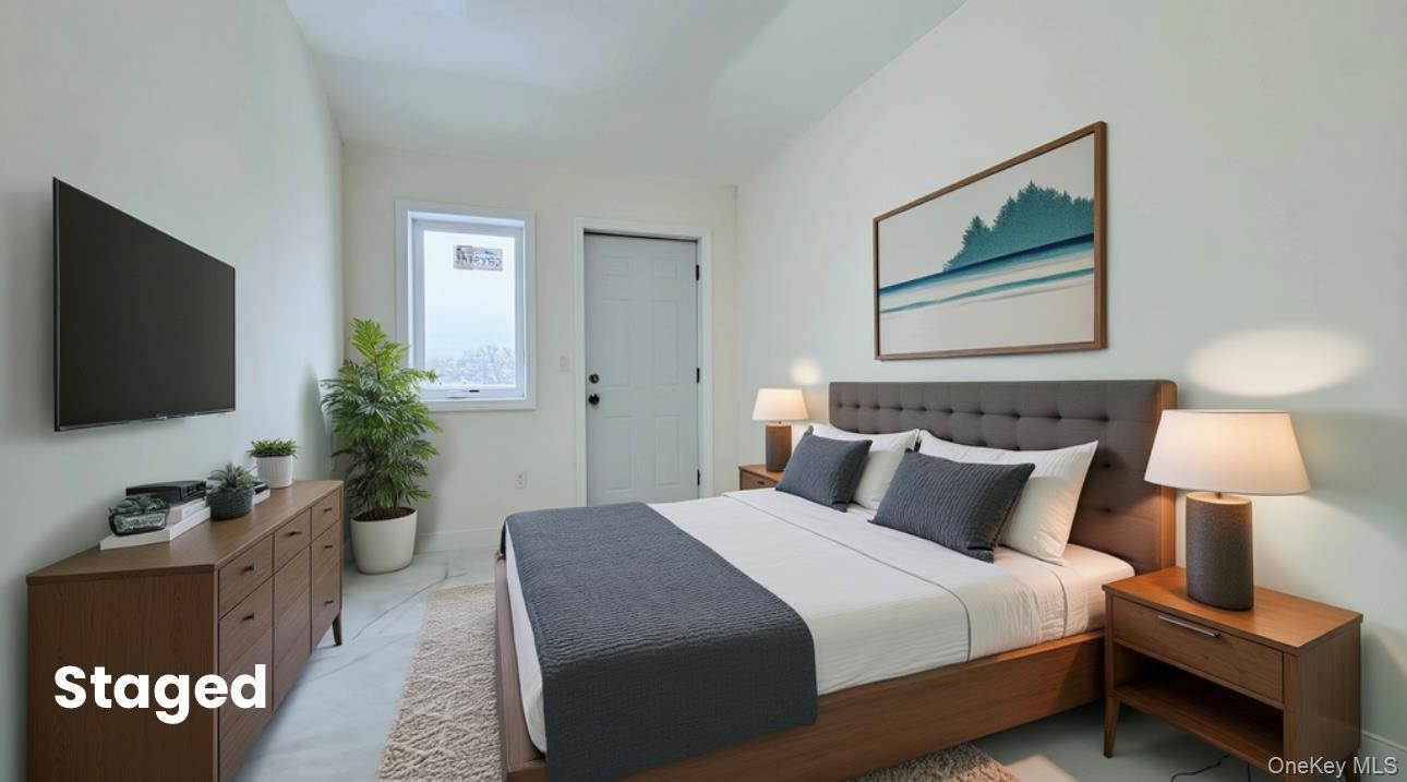 107-47 49th Avenue Queens, NY 11368 - Photo 32 of 41 a bedroom with a bed and a flat screen tv