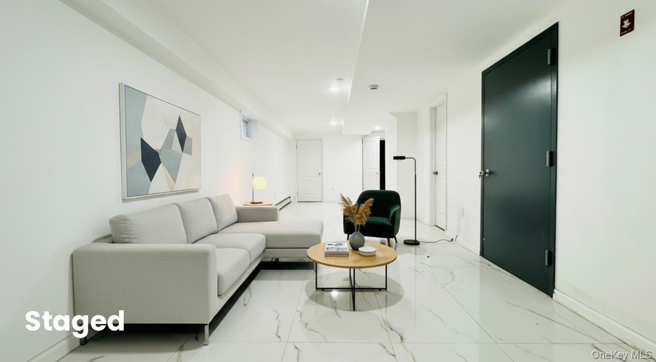 107-47 49th Avenue Queens, NY 11368 - Photo 39 of 41 a living room with furniture and a painting on the wall