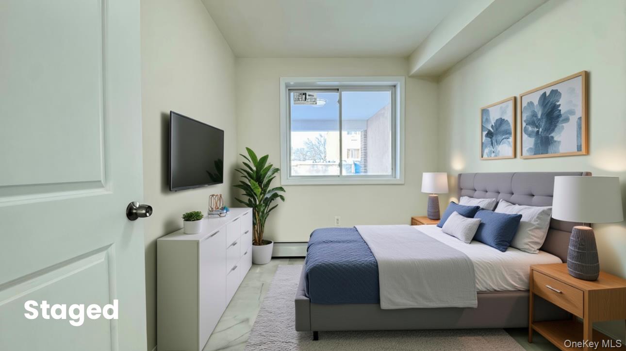 107-47 49th Avenue Queens, NY 11368 - Photo 10 of 41 a bedroom with a bed and a flat screen tv