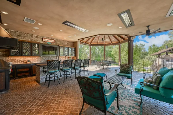 a living room with furniture a fireplace and a chandelier