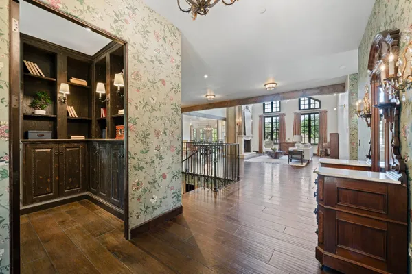 a kitchen with stainless steel appliances granite countertop a stove a sink a refrigerator and a wooden floors