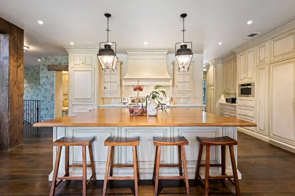 a kitchen with stainless steel appliances granite countertop a sink and a stove