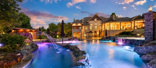 a view of a house with swimming pool and sitting area